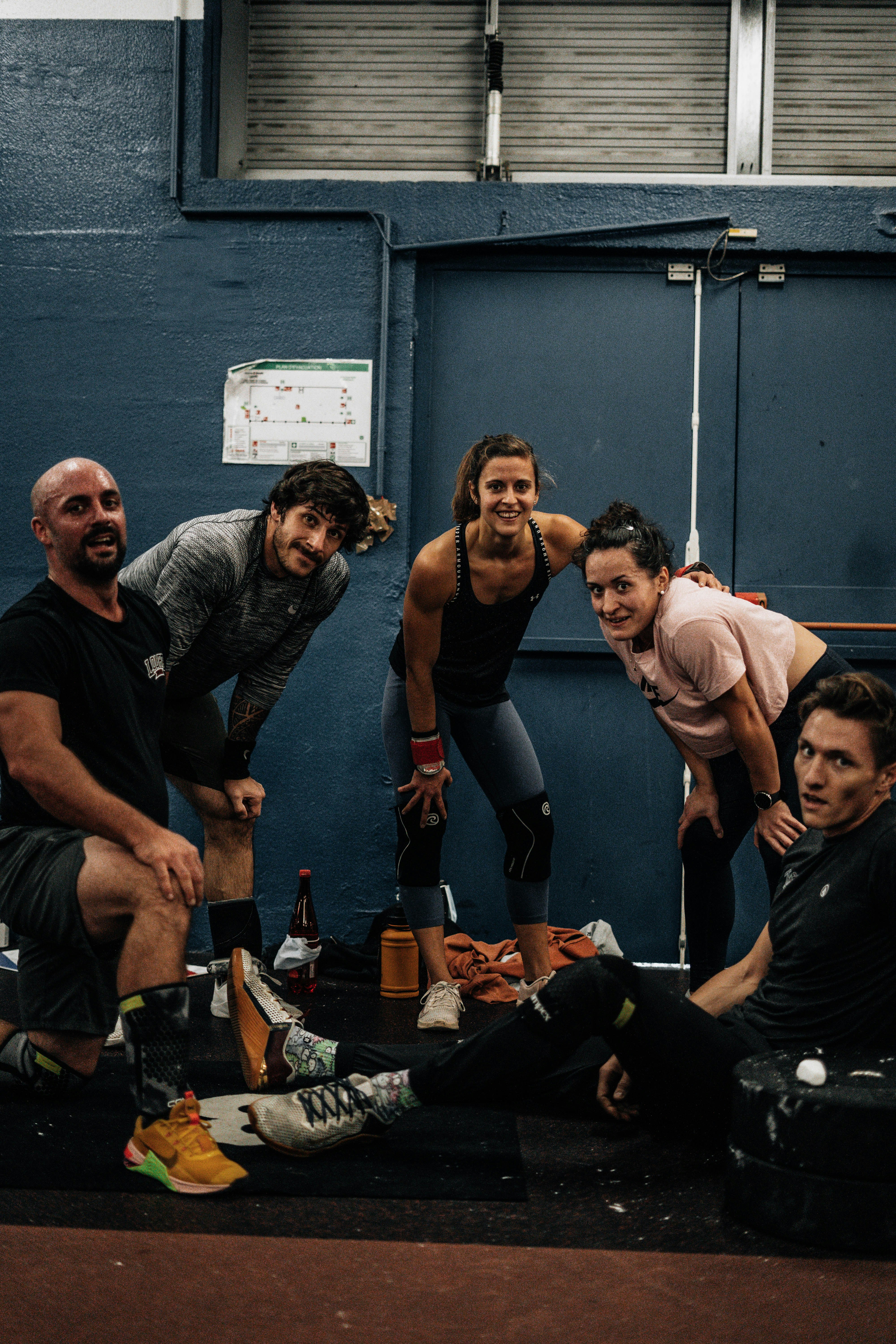 Community — group of people posing together in a gym after a workout